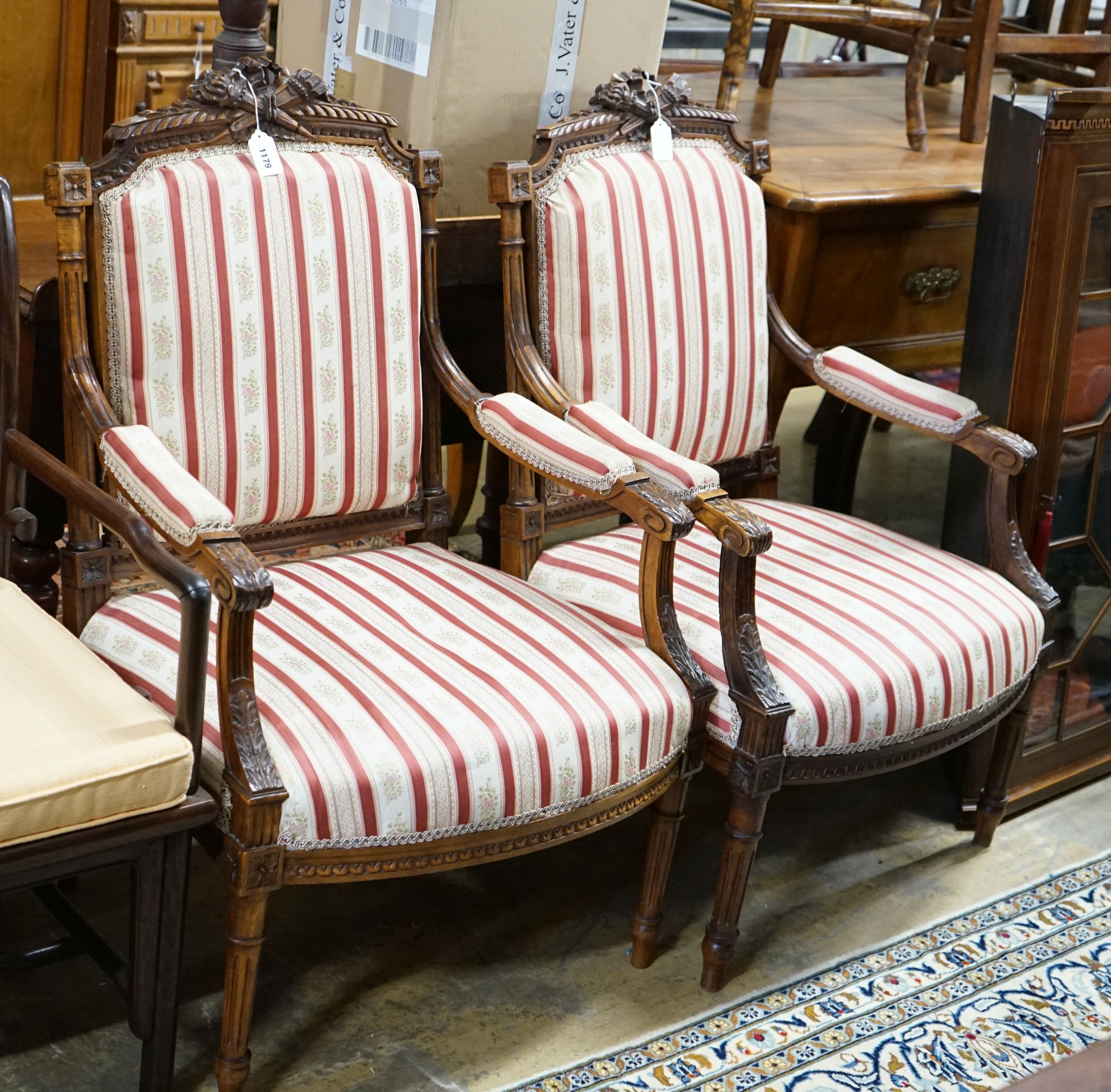 A pair of 19th century French carved walnut elbow chairs, width 61cm, depth 58cm, height 96cm